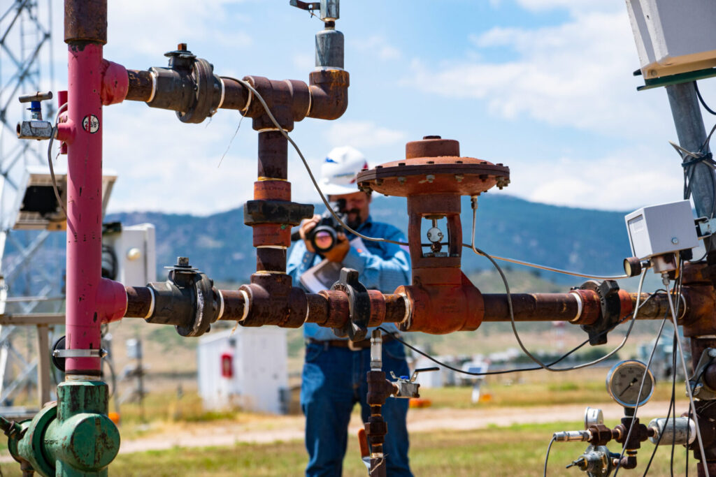 Technician with methane sensor camera