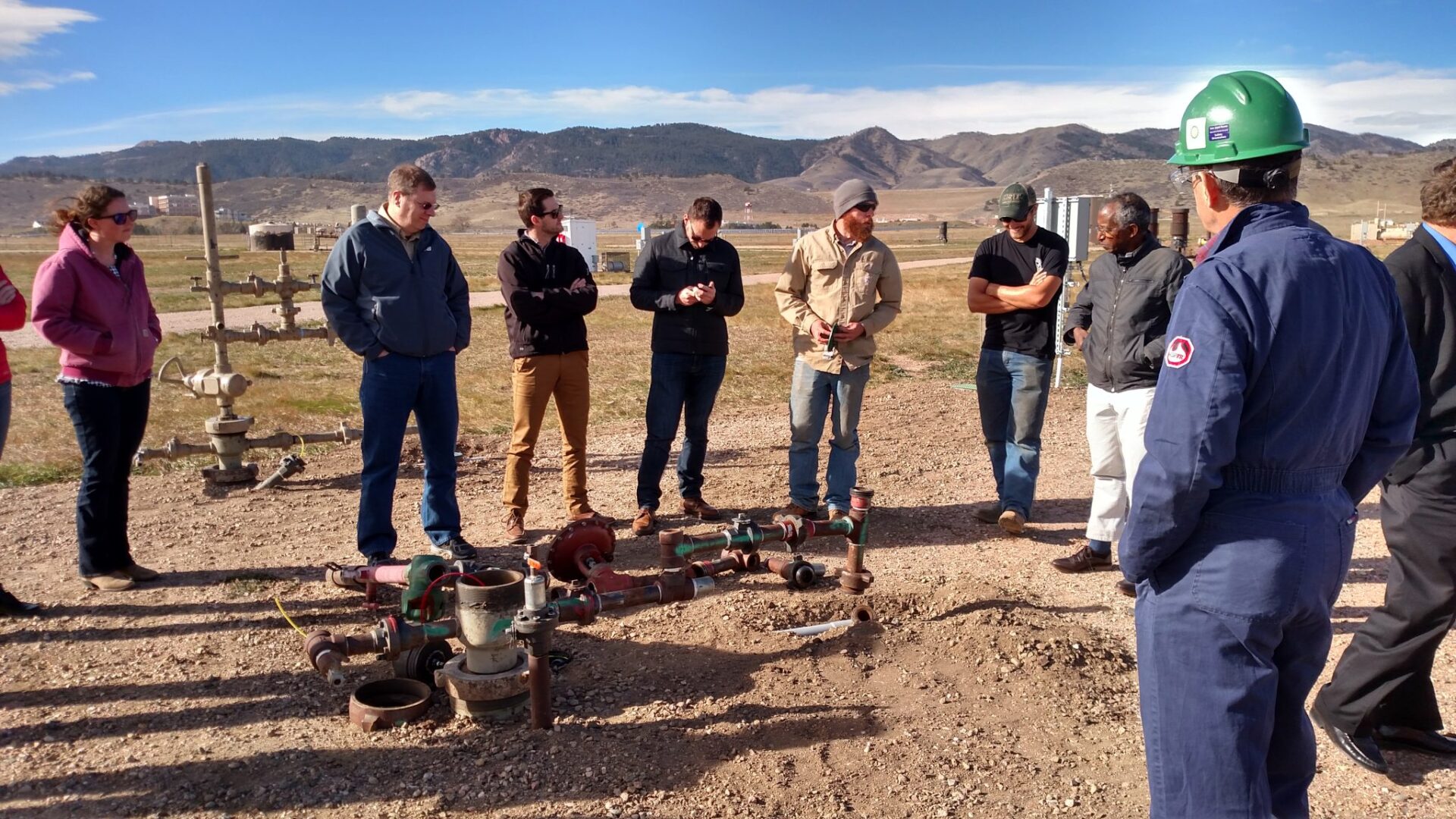 People inspecting a oil well bore