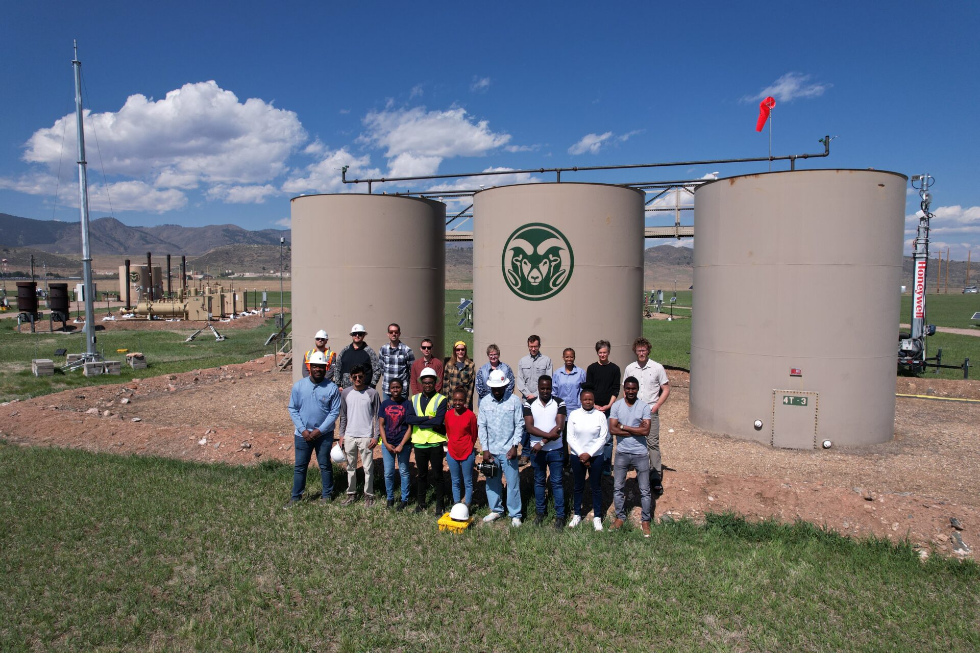 METEC staff photo in front of storage tanks